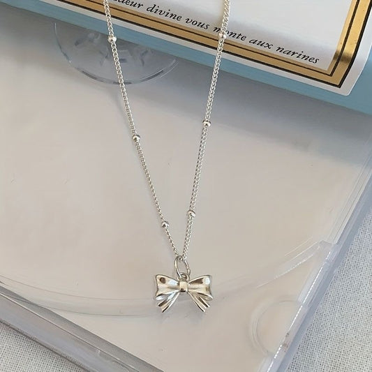 delicate silver bow necklace
